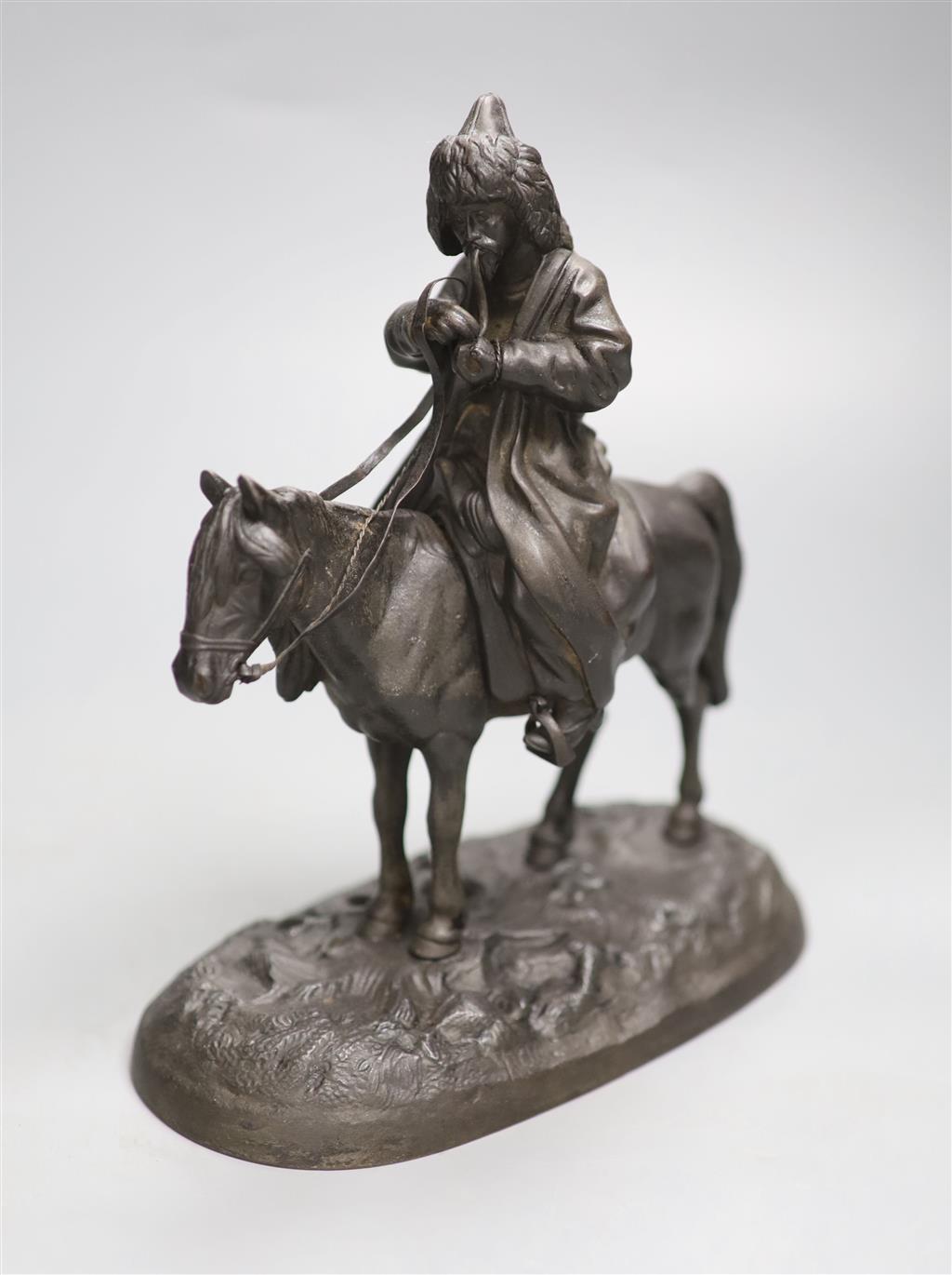 A late 19th century Russian cast iron group of a cossack on horseback